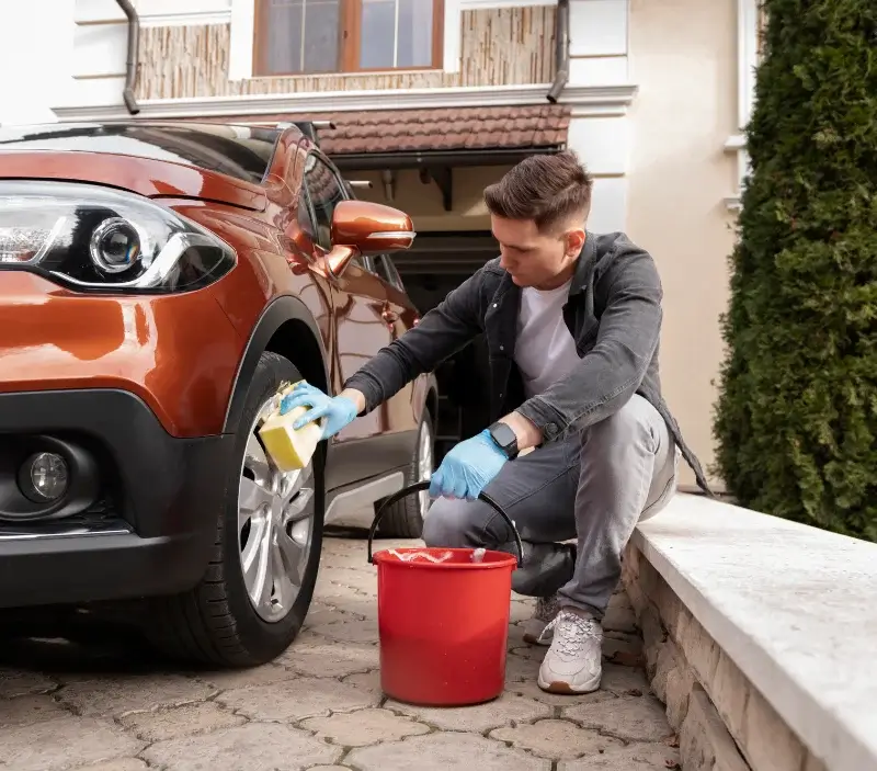 Lavage auto à domicile Saint-Eustache-la-Forêt : professionnel intervenant sur un véhicule